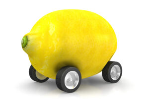 a lemon with wheels on it, meant to be used to explain Lemon Laws on cars