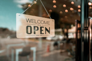a photo of an open sign in a cafe window