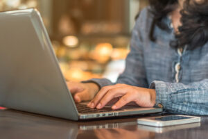a woman typing on her laptop