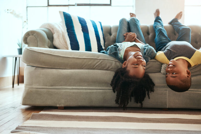 siblings playing on the sofa