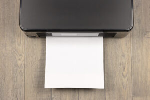 a blank piece of paper being fed into a printer