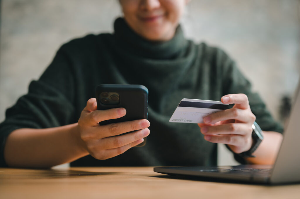 a person using a credit card to make a purchase or pay for something on their phone