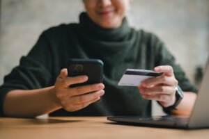 a person using a credit card to make a purchase or pay for something on their phone